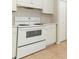 Functional kitchen featuring a white range oven, cabinets, and tile floors at 1040 Hamlet Dr, Maitland, FL 32751