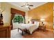 Comfortable bedroom with patterned wallpaper, large window, and elegant lamps on side tables at 11055 Ullswater Ln, Windermere, FL 34786