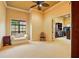 Bright bedroom with large windows, neutral decor, and access to a walk-in closet at 11055 Ullswater Ln, Windermere, FL 34786