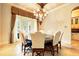 Dining room features a chandelier, travertine floor, and a table with seating for six at 11055 Ullswater Ln, Windermere, FL 34786