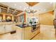 Gourmet kitchen showcasing a large island with black granite countertops and custom cabinetry at 11055 Ullswater Ln, Windermere, FL 34786