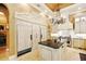 Gourmet kitchen with custom cabinets, granite countertops, a center island, and modern stainless appliances at 11055 Ullswater Ln, Windermere, FL 34786
