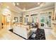 Bright living room with stone floors, a decorative ceiling, and french doors leading to the lanai at 11055 Ullswater Ln, Windermere, FL 34786