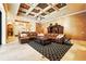 Spacious living room with coffered ceilings, hardwood floors, and a large sectional sofa at 11055 Ullswater Ln, Windermere, FL 34786