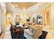 Elegant living room featuring fireplace, travertine floors, and access to the outdoor area at 11055 Ullswater Ln, Windermere, FL 34786