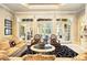 Bright living room with stone floors, a decorative ceiling, and french doors leading to the lanai at 11055 Ullswater Ln, Windermere, FL 34786