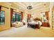 Bright main bedroom with seating area, large windows, and decorative chandelier at 11055 Ullswater Ln, Windermere, FL 34786