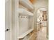 Hallway featuring coat rack and cubbies leading to the kitchen area and with tile flooring at 11055 Ullswater Ln, Windermere, FL 34786