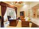 Spacious office featuring a large wooden desk, comfortable seating, and natural light at 11055 Ullswater Ln, Windermere, FL 34786