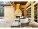 Covered patio with an outdoor fireplace and poolside seating at 11055 Ullswater Ln, Windermere, FL 34786