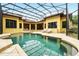 Backyard screened pool with patio seating, offering a luxurious outdoor experience at 11055 Ullswater Ln, Windermere, FL 34786