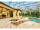 Inviting screened-in pool area with attached hot tub and ample patio space for outdoor living at 11055 Ullswater Ln, Windermere, FL 34786