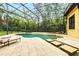 Relaxing screened pool area with patio and lounge chairs surrounded by lush landscaping at 11055 Ullswater Ln, Windermere, FL 34786
