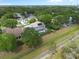 An aerial view of a home surrounded by trees with a screened-in pool and solar panels on the roof at 1128 Brantley Estates Dr, Altamonte Springs, FL 32714