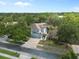 An aerial view of a beautiful two-story home with lush landscaping, a two-car garage and brick-paved driveway at 1128 Brantley Estates Dr, Altamonte Springs, FL 32714