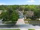 An aerial view of a charming home featuring lush landscaping, a two-car garage, and a brick-paved driveway at 1128 Brantley Estates Dr, Altamonte Springs, FL 32714