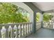 Open balcony with white columns offers views of the neighborhood and mature trees, creating a charming outdoor space at 1128 Brantley Estates Dr, Altamonte Springs, FL 32714