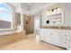 Bright bathroom featuring a soaking tub, glass-enclosed shower, and double vanity with granite countertop at 1128 Brantley Estates Dr, Altamonte Springs, FL 32714