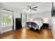 Comfortable bedroom featuring a metal bed frame, hardwood floors, and natural light at 1128 Brantley Estates Dr, Altamonte Springs, FL 32714