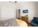 Cozy bedroom features a window, closet, TV and hardwood floors offering a relaxing and inviting atmosphere at 1128 Brantley Estates Dr, Altamonte Springs, FL 32714
