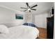Bright bedroom features a ceiling fan, TV, closet, and hardwood floors for a comfortable and stylish living space at 1128 Brantley Estates Dr, Altamonte Springs, FL 32714