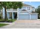 Charming two-story light blue home with well-manicured lawn and a three-car garage at 1128 Brantley Estates Dr, Altamonte Springs, FL 32714