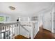 Second-floor landing with wood floors, white railings, and decorative chandelier at 1128 Brantley Estates Dr, Altamonte Springs, FL 32714