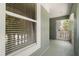 View of a hallway with a window and a view of a balcony and trees through a window at 1128 Brantley Estates Dr, Altamonte Springs, FL 32714