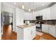 Bright kitchen with white cabinets, stainless appliances, granite countertops and island with bar seating at 1128 Brantley Estates Dr, Altamonte Springs, FL 32714