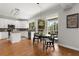 Bright kitchen with island, stainless appliances, hardwood floors and breakfast nook with sliding glass door to patio at 1128 Brantley Estates Dr, Altamonte Springs, FL 32714
