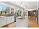 Bright kitchen with white cabinets, stainless appliances, granite countertops and island with bar seating at 1128 Brantley Estates Dr, Altamonte Springs, FL 32714