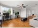 A bright living room features hardwood floors, closet and a comfortable seating area by a window at 1128 Brantley Estates Dr, Altamonte Springs, FL 32714