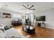 Spacious living room with hardwood floors, ceiling fan, TV, and furniture offers a comfortable area for relaxation at 1128 Brantley Estates Dr, Altamonte Springs, FL 32714