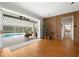 Living room with hardwood floors that opens to an outdoor pool and patio area at 1128 Brantley Estates Dr, Altamonte Springs, FL 32714