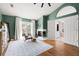 Green main bedroom with hardwood floors, fireplace, sitting area, and ensuite bathroom access at 1128 Brantley Estates Dr, Altamonte Springs, FL 32714