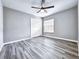 Bedroom featuring plank flooring, a ceiling fan, and a window providing natural light at 1200 Montheath Cir, Ocoee, FL 34761