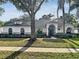 Charming one-story home with a well-manicured lawn, arched entry, and mature landscaping at 1200 Montheath Cir, Ocoee, FL 34761