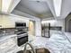 Bright kitchen with stainless steel appliances, granite countertops, and white cabinetry at 1200 Montheath Cir, Ocoee, FL 34761
