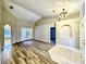 Open living area with modern lighting, vaulted ceiling, and wood-look flooring at 1200 Montheath Cir, Ocoee, FL 34761