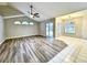 Open-concept living room with wood flooring and access to a screened lanai, adjacent to dining area at 1200 Montheath Cir, Ocoee, FL 34761