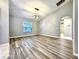 Spacious living room featuring vaulted ceilings, modern light fixture, and beautiful floors at 1200 Montheath Cir, Ocoee, FL 34761