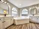 Primary bath featuring soaking tub, dual sinks and vanities, and stylish fixtures at 1200 Montheath Cir, Ocoee, FL 34761