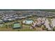 Aerial shot of a community with a tennis court, pool area, clubhouse, and parking lot at 12048 Imaginary Way, Orlando, FL 32832