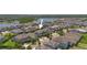 Aerial view of a residential area featuring modern homes, green spaces, and a pond at 12048 Imaginary Way, Orlando, FL 32832