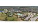 Aerial view of a community featuring a clubhouse, pool, tennis court, and manicured landscaping at 12048 Imaginary Way, Orlando, FL 32832