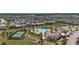Aerial view showcasing a community with a clubhouse, swimming pool, tennis court, and parking area at 12048 Imaginary Way, Orlando, FL 32832