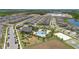 Aerial view showcasing the community pool, playground, and volleyball and basketball courts near the lake at 12048 Imaginary Way, Orlando, FL 32832