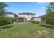 Well-maintained backyard with a lawn, pergola, and screen patio at 12048 Imaginary Way, Orlando, FL 32832