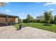 Spacious backyard featuring a paver patio, lush lawn, and a stylish covered outdoor seating area at 12048 Imaginary Way, Orlando, FL 32832