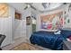 Cozy bedroom with a bold accent wall, comfortable bed, and unique artwork, creating a personalized space at 12048 Imaginary Way, Orlando, FL 32832